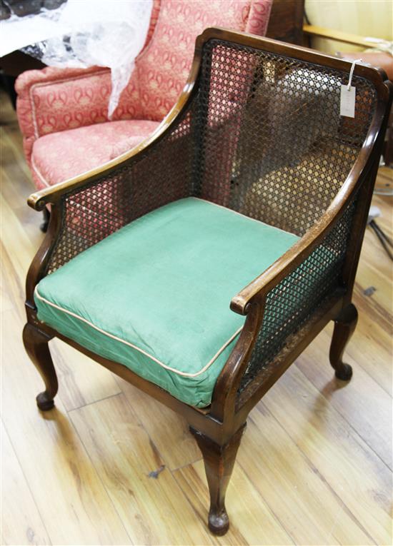 A 1920s beech framed single caned bergere armchair,